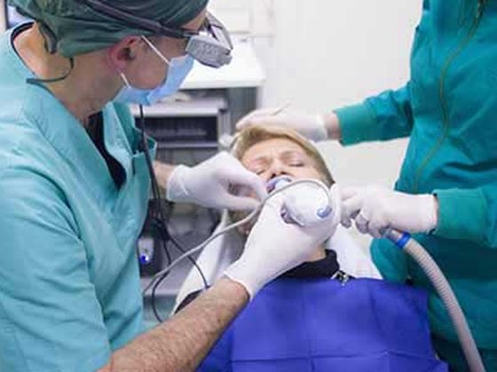 Dental team caring for a patient in our clinic