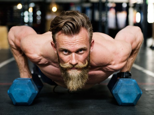 Man training with dumbbells during a strength session