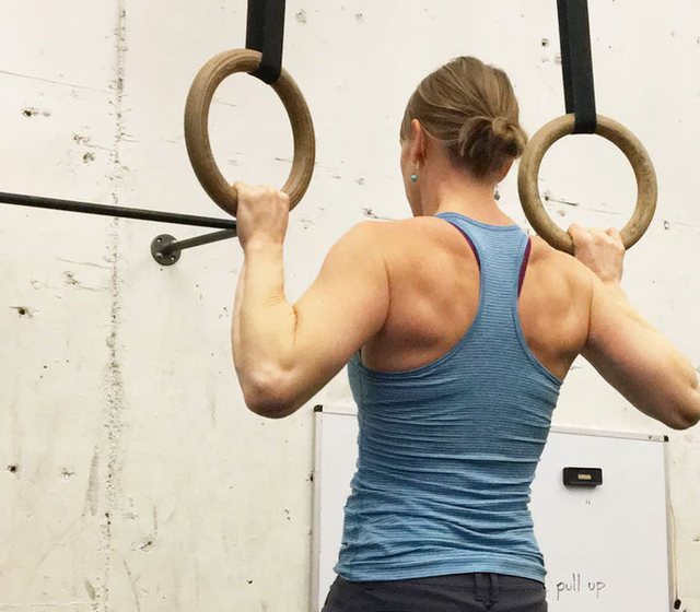 Woman training on gymnastic rings